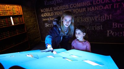 Teenager and Child experiencing interactive exhibition at EPIC Museum of Emigration