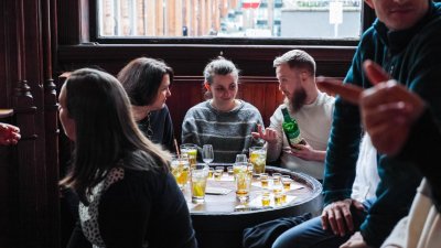 three people talking in a pub 
